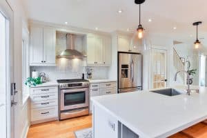 White kitchen with clean bright countertops and cabinets.